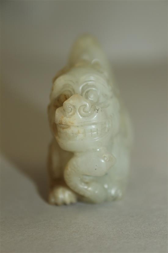 A Chinese pale celadon jade group of a lion-dog and a snake, 6.3cm